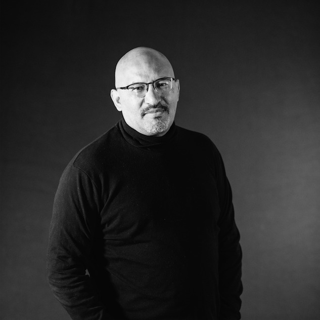 Black and white portrait of journalist and author Roberto Lovato
